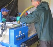 Bill fills the bags of the pressing machine with pommace