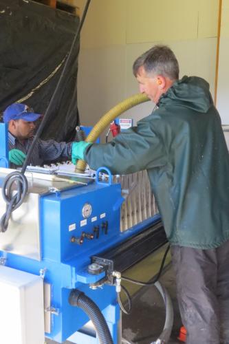 Bill fills the bags of the pressing machine with pommace