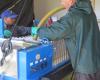 Bill fills the bags of the pressing machine with pommace